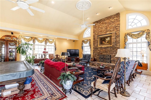 living room with high vaulted ceiling, a ceiling fan, and a healthy amount of sunlight