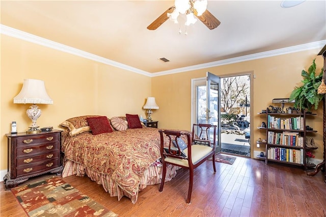 bedroom with visible vents, ornamental molding, ceiling fan, wood finished floors, and access to outside