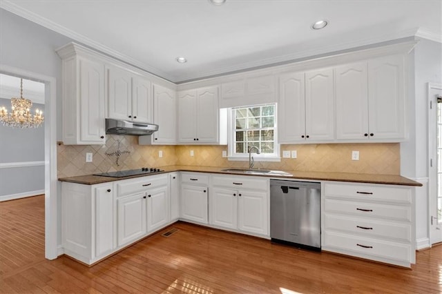 kitchen featuring under cabinet range hood, stainless steel dishwasher, light wood-style floors, black electric cooktop, and a sink