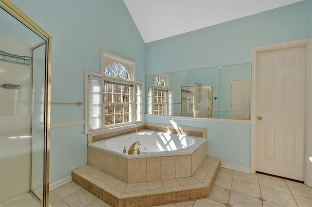 full bath featuring tile patterned floors, a garden tub, a stall shower, and high vaulted ceiling