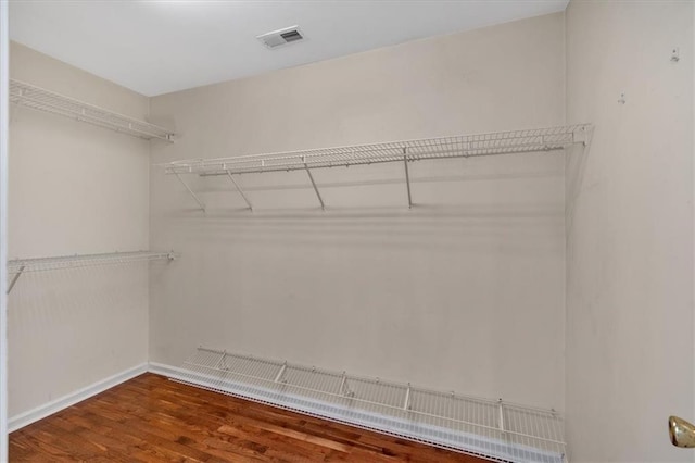 walk in closet with wood finished floors and visible vents