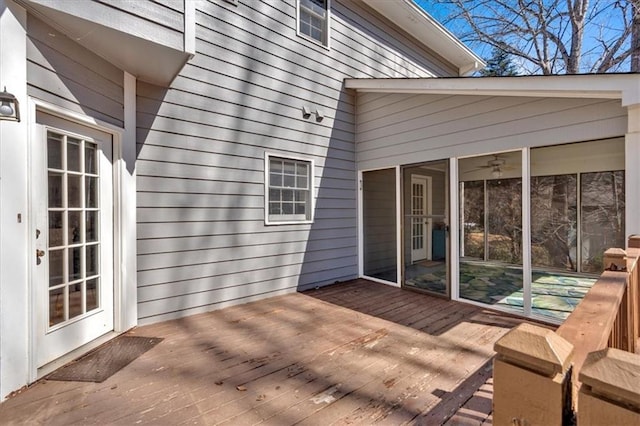 wooden deck with a sunroom