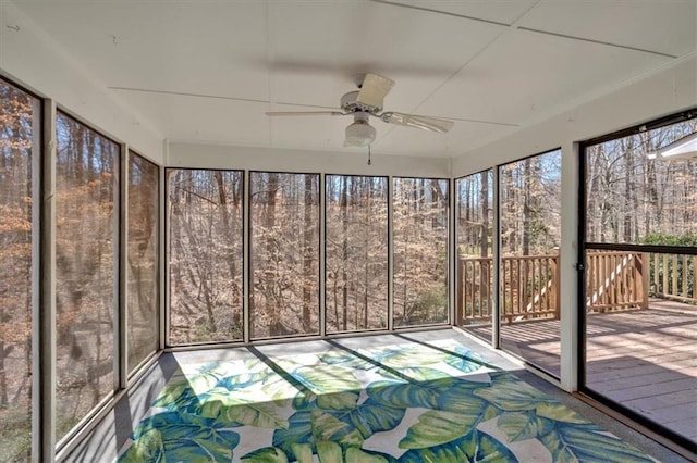 unfurnished sunroom with ceiling fan