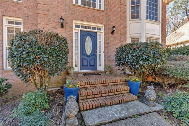 view of exterior entry with brick siding