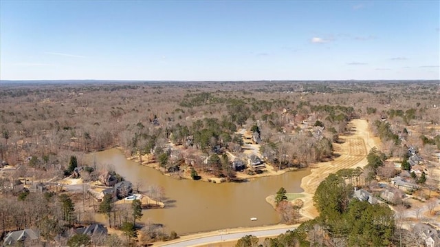 aerial view featuring a forest view and a water view