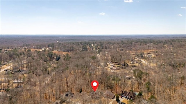 birds eye view of property with a forest view