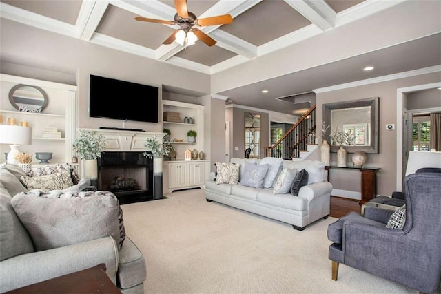 carpeted living room featuring ceiling fan, beamed ceiling, coffered ceiling, and ornamental molding