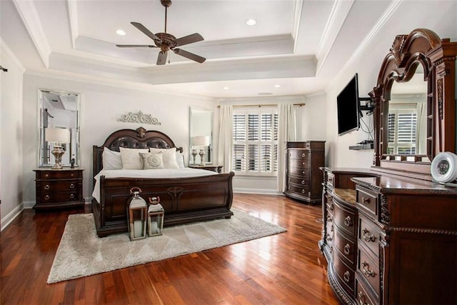 bedroom featuring a tray ceiling, ceiling fan, dark hardwood / wood-style floors, and ornamental molding