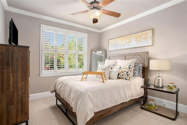 bedroom with carpet floors, ceiling fan, and crown molding