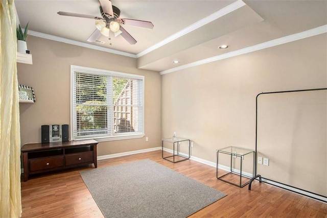 sitting room featuring ceiling fan, wood-type flooring, and ornamental molding