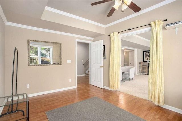 empty room with hardwood / wood-style flooring, ceiling fan, and ornamental molding