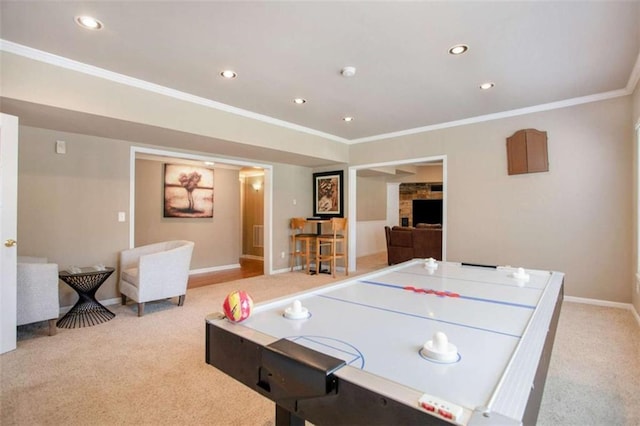 playroom featuring a stone fireplace, light carpet, and ornamental molding