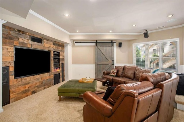 living room featuring a barn door, wooden walls, carpet floors, and ornamental molding