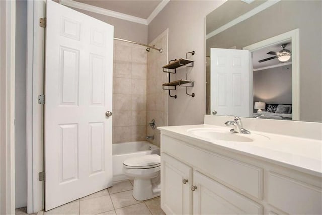 full bathroom with tile patterned floors, ceiling fan, tiled shower / bath combo, toilet, and ornamental molding