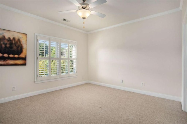 carpeted empty room with ceiling fan and crown molding