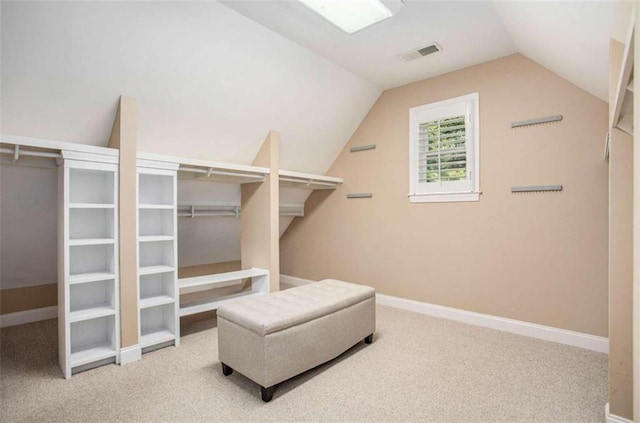 spacious closet featuring carpet floors and vaulted ceiling