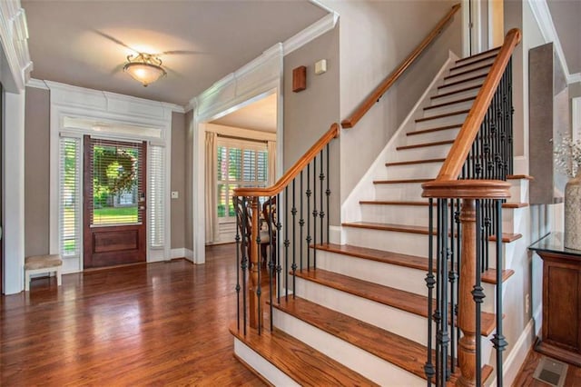 entrance foyer featuring dark hardwood / wood-style flooring and ornamental molding