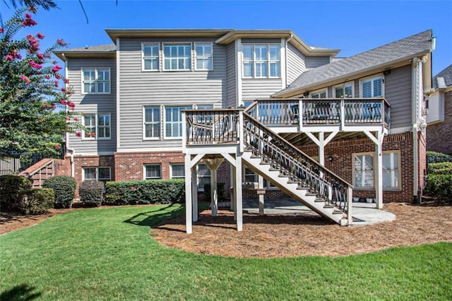 back of property featuring a yard and a wooden deck