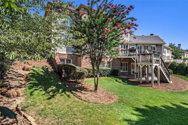 back of house featuring a lawn and a deck