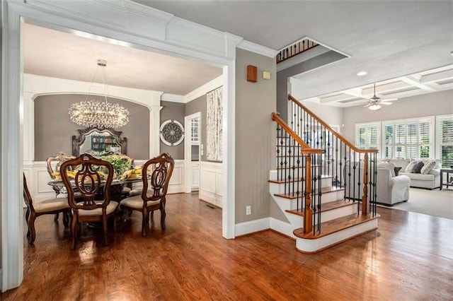 dining space with beam ceiling, ceiling fan with notable chandelier, hardwood / wood-style flooring, and coffered ceiling