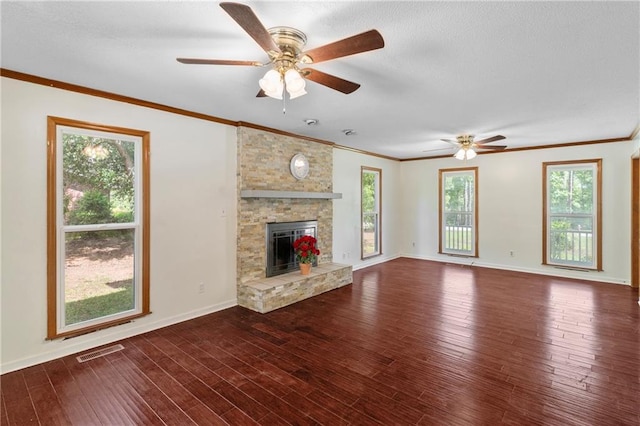 342 Spring Valley Rd, Waynesboro, GA 30830 - unfurnished living room with ceiling fan, dark wood finished floors, a stone fireplace, crown molding, and baseboards