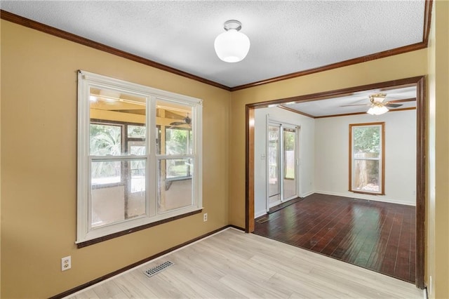 342 Spring Valley Rd, Waynesboro, GA 30830 - empty room with wood finished floors, ornamental molding, a textured ceiling, and baseboards