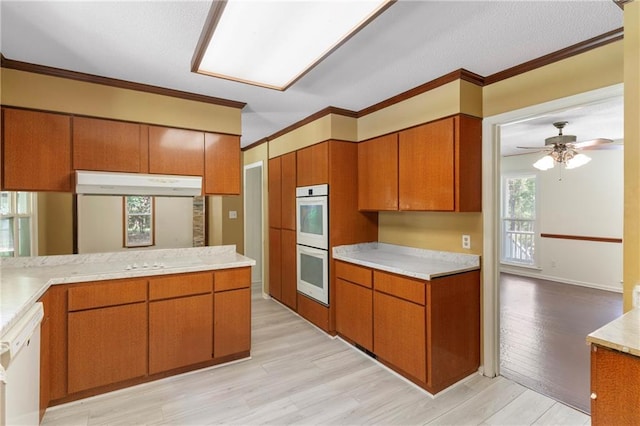 342 Spring Valley Rd, Waynesboro, GA 30830 - kitchen with white appliances, brown cabinets, light countertops, light wood-type flooring, and ceiling fan