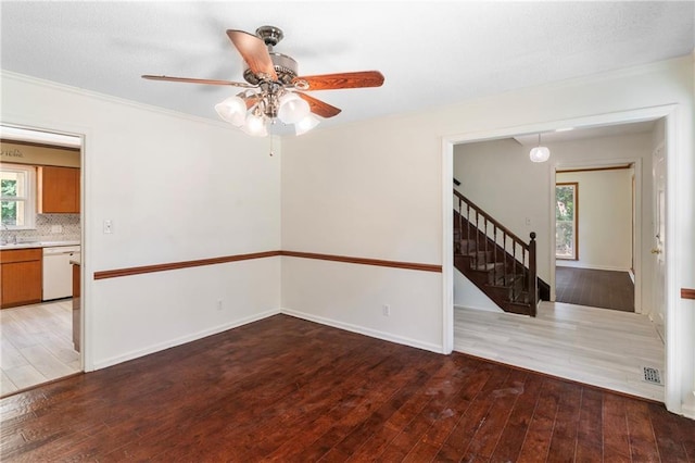 342 Spring Valley Rd, Waynesboro, GA 30830 - unfurnished room with hardwood / wood-style floors, a ceiling fan, stairway, ornamental molding, and baseboards