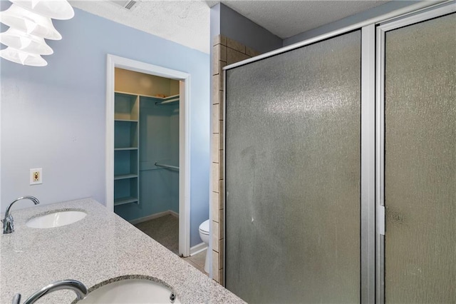 342 Spring Valley Rd, Waynesboro, GA 30830 - full bath featuring a spacious closet, a stall shower, double vanity, and toilet