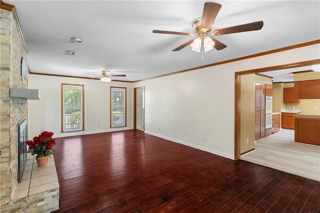 342 Spring Valley Rd, Waynesboro, GA 30830 - unfurnished living room featuring a ceiling fan, light wood-style flooring, a fireplace, crown molding, and baseboards