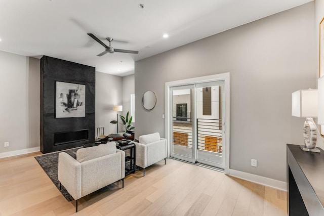 living room with ceiling fan and light hardwood / wood-style floors