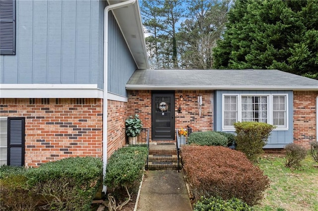 entrance to property featuring brick siding