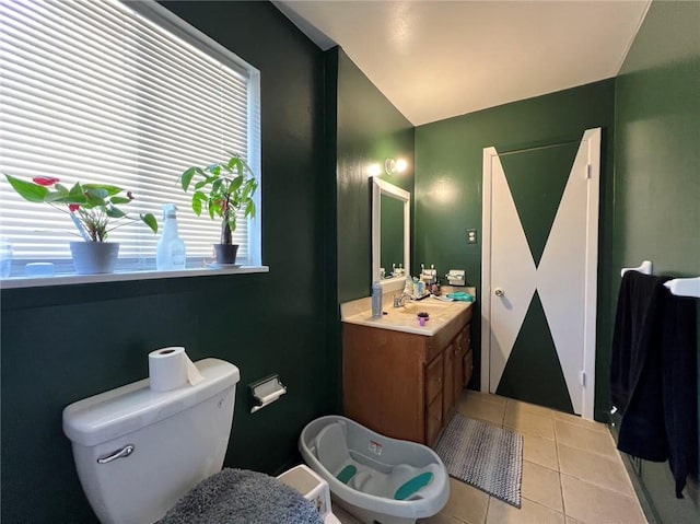 bathroom with vanity, toilet, and tile patterned flooring