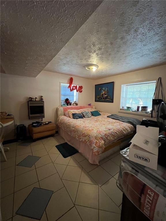 tiled bedroom featuring a textured ceiling