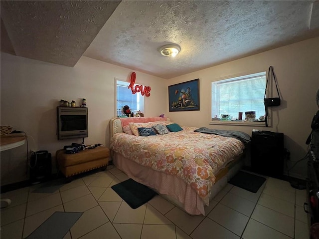 tiled bedroom with a textured ceiling