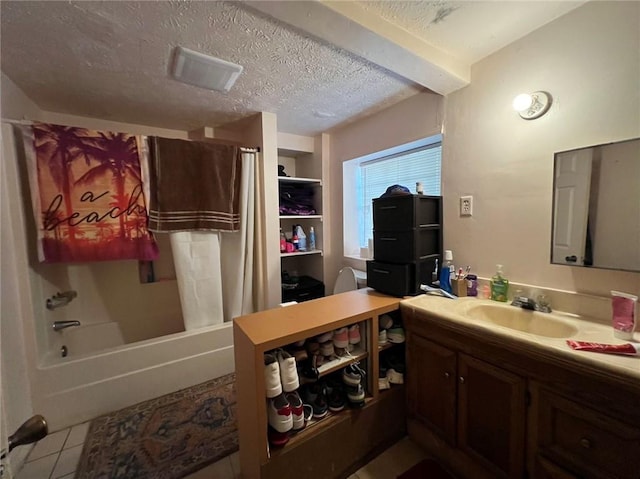 bathroom with vanity, a textured ceiling, shower / bath combo, and tile patterned flooring