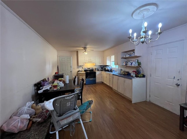 kitchen featuring ceiling fan with notable chandelier, stainless steel range with electric stovetop, pendant lighting, crown molding, and dark hardwood / wood-style floors