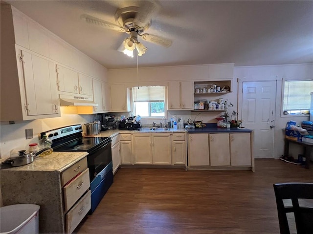 kitchen featuring dark wood-type flooring, sink, black / electric stove, white cabinetry, and ceiling fan