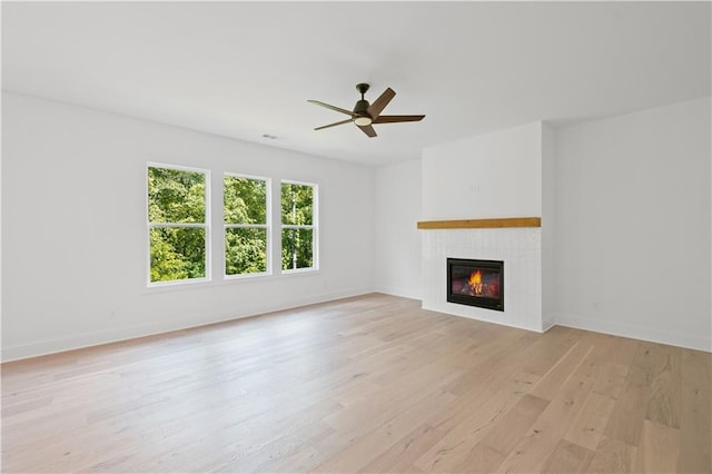 729 Keystone Dr, Woodstock, GA 30188 - unfurnished living room with a fireplace, light wood-style floors, ceiling fan, and baseboards