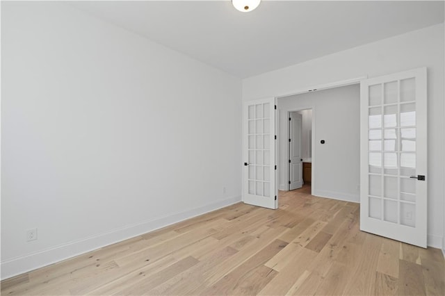 729 Keystone Dr, Woodstock, GA 30188 - spare room featuring french doors, light wood-type flooring, and baseboards