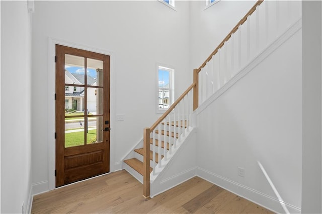 729 Keystone Dr, Woodstock, GA 30188 - entrance foyer featuring plenty of natural light, light wood-type flooring, stairway, a towering ceiling, and baseboards