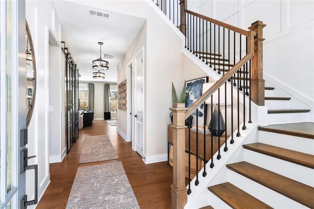 729 Keystone Dr, Woodstock, GA 30188 - entryway featuring stairs, wood finished floors, baseboards, and a chandelier