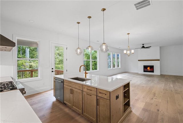 729 Keystone Dr, Woodstock, GA 30188 - kitchen with a sink, open shelves, stainless steel dishwasher, light wood finished floors, and a lit fireplace
