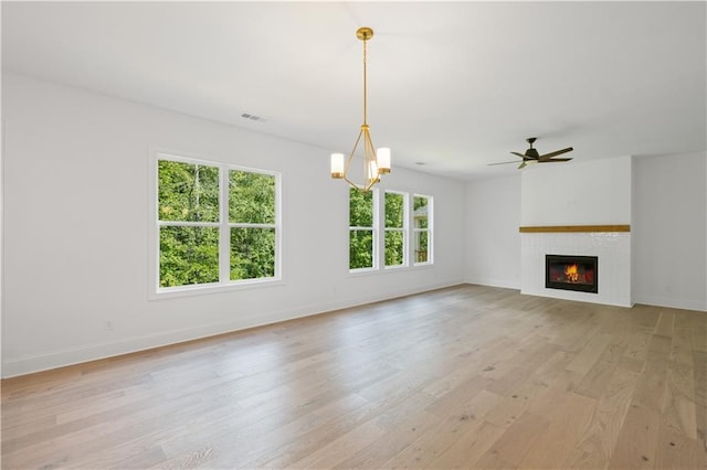 729 Keystone Dr, Woodstock, GA 30188 - unfurnished living room with light wood-type flooring, a glass covered fireplace, baseboards, and ceiling fan