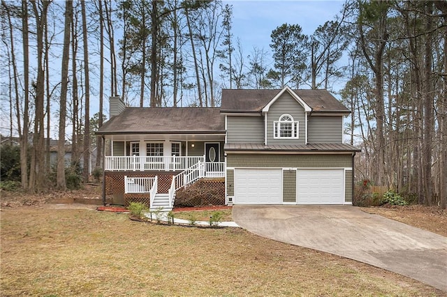 tri-level home featuring a chimney, a porch, concrete driveway, a garage, and stairs