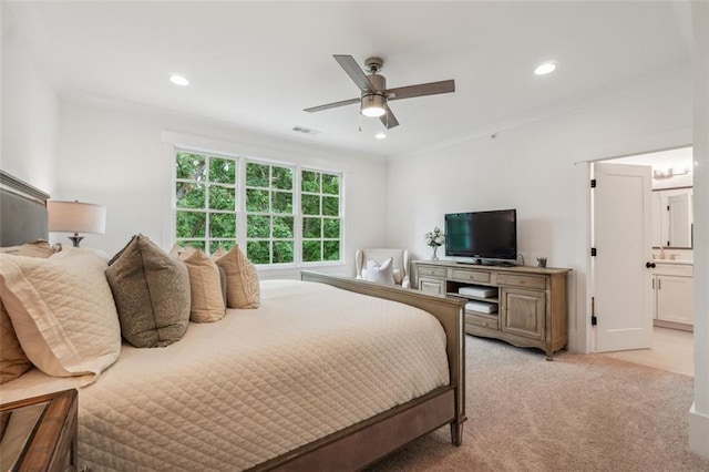 bedroom featuring ensuite bath, recessed lighting, visible vents, and light colored carpet