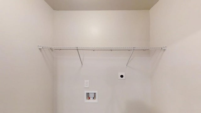 clothes washing area with electric dryer hookup and washer hookup
