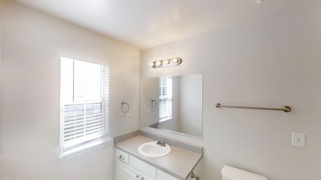 bathroom featuring toilet and vanity