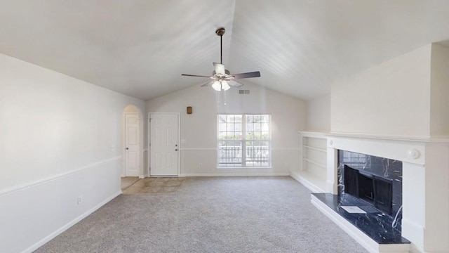 unfurnished living room with ceiling fan, carpet flooring, a fireplace, lofted ceiling, and baseboards