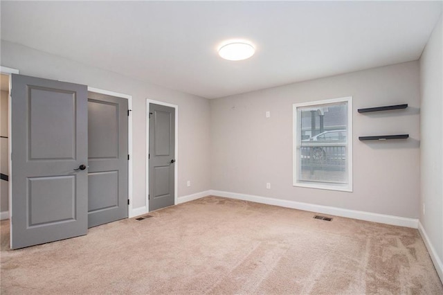 unfurnished bedroom featuring light carpet